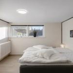 Bedroom with bed, window, and wall art.