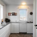Kitchen with worktop, sink, dishwasher, and window with view.