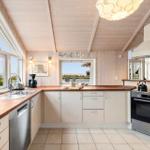 Kitchen with wooden surfaces, windows, and appliances.