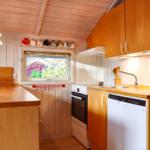 Kitchen with wooden surfaces, window, and integrated appliances.