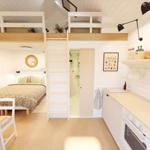 Kitchen with countertop, bedroom with double bed and bunk beds.