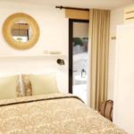 Bedroom with bed, mirror, and curtain