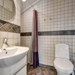 Bathroom with sink, toilet, and shower with curtain.