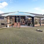 House with large courtyard, terrace, and glass roof. Outdoor grill and lounge chairs are available.