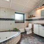 Bath with whirlpool, toilet, and sink with mirror