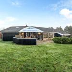 A house with a large garden and glass roof over the terrace.