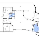 Apartment with two bedrooms, kitchen, and two bathrooms. Hallway with stairs.