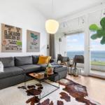Living room with sofa, coffee table, and sea view.