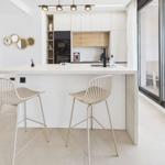 Kitchen with bar stools and view of living area