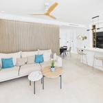 Living and kitchen area with sofa, dining table, and kitchen island.