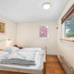 Bedroom with bed, window, and wall art