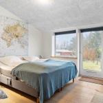 Bedroom with bed, world map on wall, and window to outdoor terrace.
