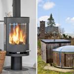 Inside: wood stove with burning fire. Outside: wooden hot tub with cover and bench.