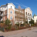 Haus mit Balkonen und Ziegelfassade an sonnigem Tag