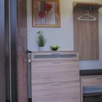 Entrance area with shoe cabinet, coat hanger, and plants.