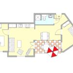 Wohnung mit Küche, Schlafzimmer, Bad und Terrasse mit Sonnenschirm.