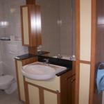 Bathroom with sink, mirror, toilet, and blue hanging fixture
