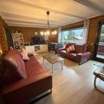 Living room with red sofa, TV, and view of balcony