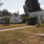 Haus mit Garten, Waschleine und Blumenbeet. Pfad führt zur Eingangstür.