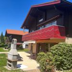 House with balcony, terrace, and grill area in the garden.