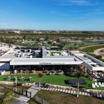 La Reserva Beach Sport Club with terrace, tables, and palm trees.