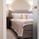 Schlafzimmer mit Bett, Kissen und Wandlampen