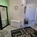 Entrance area with mirror, shoe cabinet, and city-name rug.