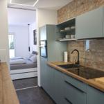 Crafted by a carpenter Kitchenette with a view towards the bedroom and balcony