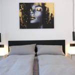 Bedroom with double bed and a beautiful work of art above the bed