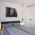 Comfortable double bed and sliding door to the living area