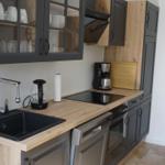 Kitchen with dark cabinets, wooden surfaces, and modern equipment.