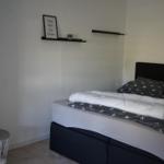 Bedroom with bed, wall shelf, and small table