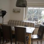 Dining room with table, four chairs, and window to terrace.