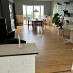 House with dining room, wooden floor, and large window to terrace.