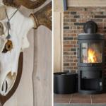 Hirschgeweih und Schädel an der Wand. Kaminofen mit brennendem Feuer und Holzkohlebehälter.