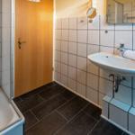 Bathroom with shower, sink, and mirror