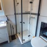 Bathroom with shower, sink, and toilet.