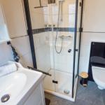 Bathroom with shower, sink, and toilet