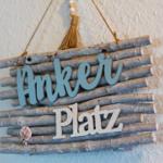 Sign made of branches with the words Anker Platz and shell