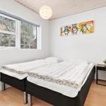 Bedroom with double bed, window, and wall art.