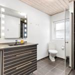 Bathroom with sink, mirror, toilet, and shower