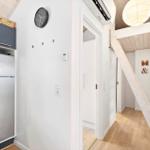 Kitchen with refrigerator and stairs to upper level.