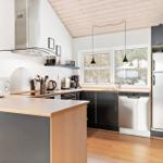 Kitchen with countertop, refrigerator, sink, and window.