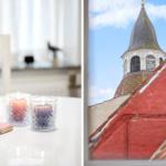 Table with lit candles and playing cards. View of church tower with red roof.