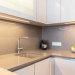 Küche mit Arbeitsplatte, Spüle und Obstschale.