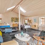 Living and dining area with sofa, table, and TV.