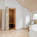 Bathroom with whirlpool, sauna, and shower