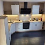 Modern kitchen with worktop, sink, stove, and extractor hood.