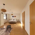 Bedroom with bed, wardrobe, and two pendant lamps.