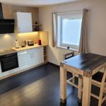 Kitchen with dining table, window, and appliances